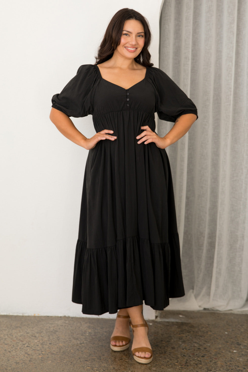 A model wearing the Austin Midi Tencel Blend Dress in colour Black (Black), from the front, showing the whole outfit