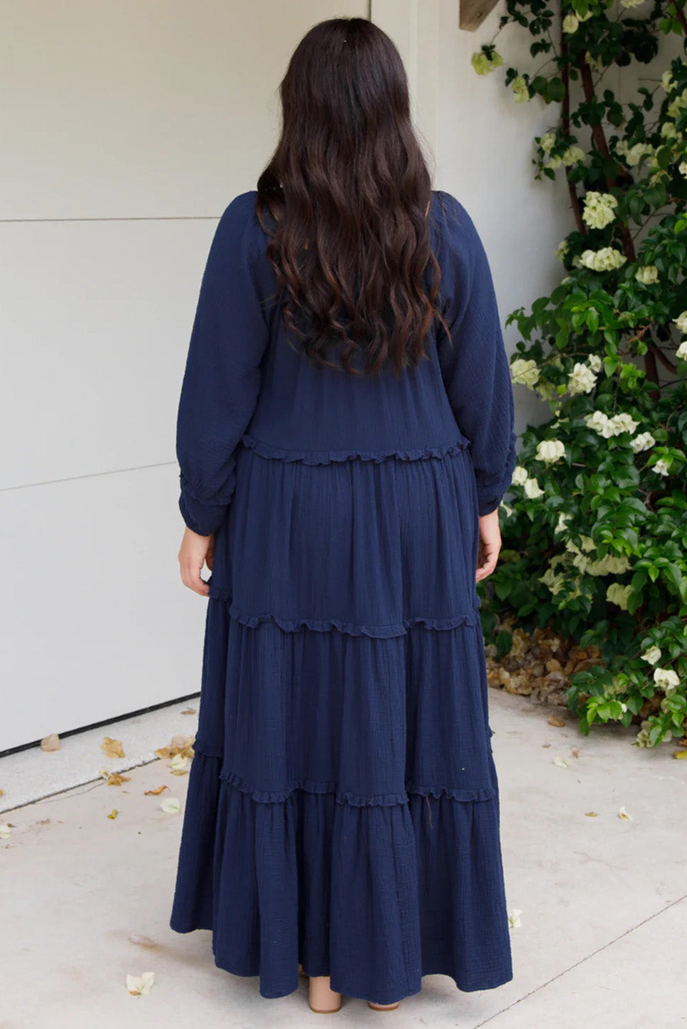 A model wearing the Lottie Midi Cotton Dress in colour Deepsea (Blue), from the back