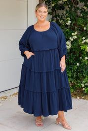 A model wearing the Lottie Midi Cotton Dress in colour Deepsea (Blue), from the front, showing the whole outfit