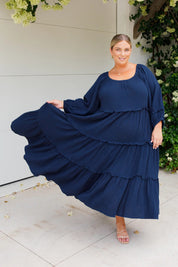 A model wearing the Lottie Midi Cotton Dress in colour Deepsea (Blue), from the front, showing the whole outfit