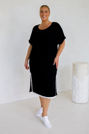 A model wearing the Gigi Lounge Dress in colour Black (Black), from the front, showing the whole outfit