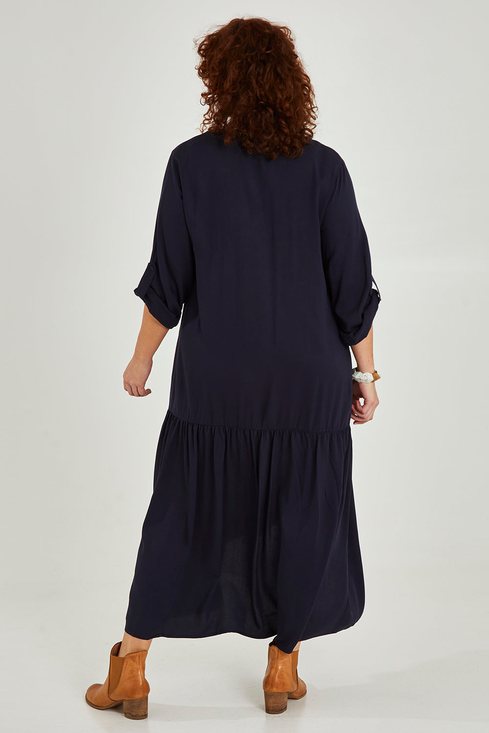 Model Maddy wearing the Long Sleeve Peak Maxi Dress in colour Navy (Blue), from the back