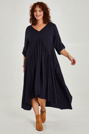 Model Maddy wearing the Long Sleeve Peak Maxi Dress in colour Navy (Blue), from the front, showing the whole outfit