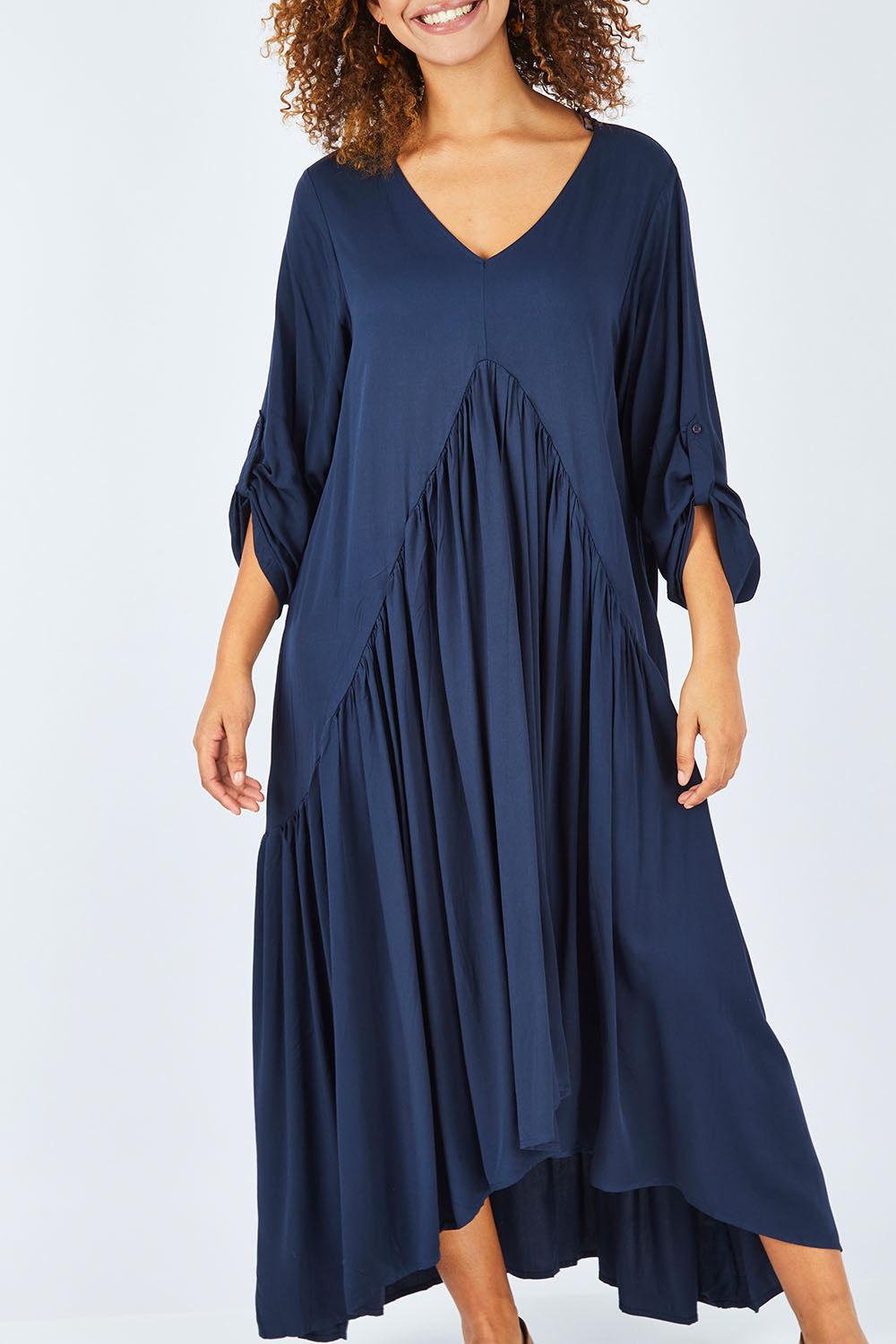 Model Summer wearing the Long Sleeve Peak Maxi Dress in colour Navy (Blue), from the front, cropped image