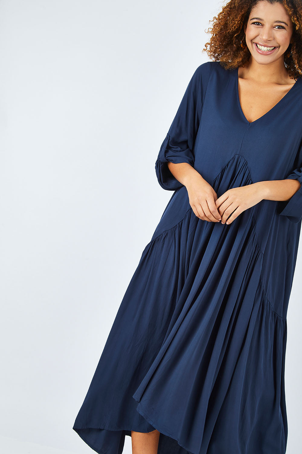 Model Summer wearing the Long Sleeve Peak Maxi Dress in colour Navy (Blue), from the front, cropped image