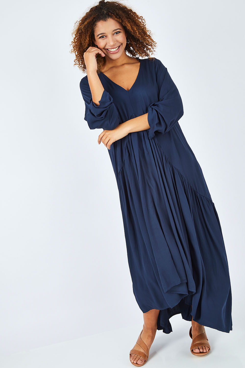 Model Summer wearing the Long Sleeve Peak Maxi Dress in colour Navy (Blue), from the front, showing the whole outfit