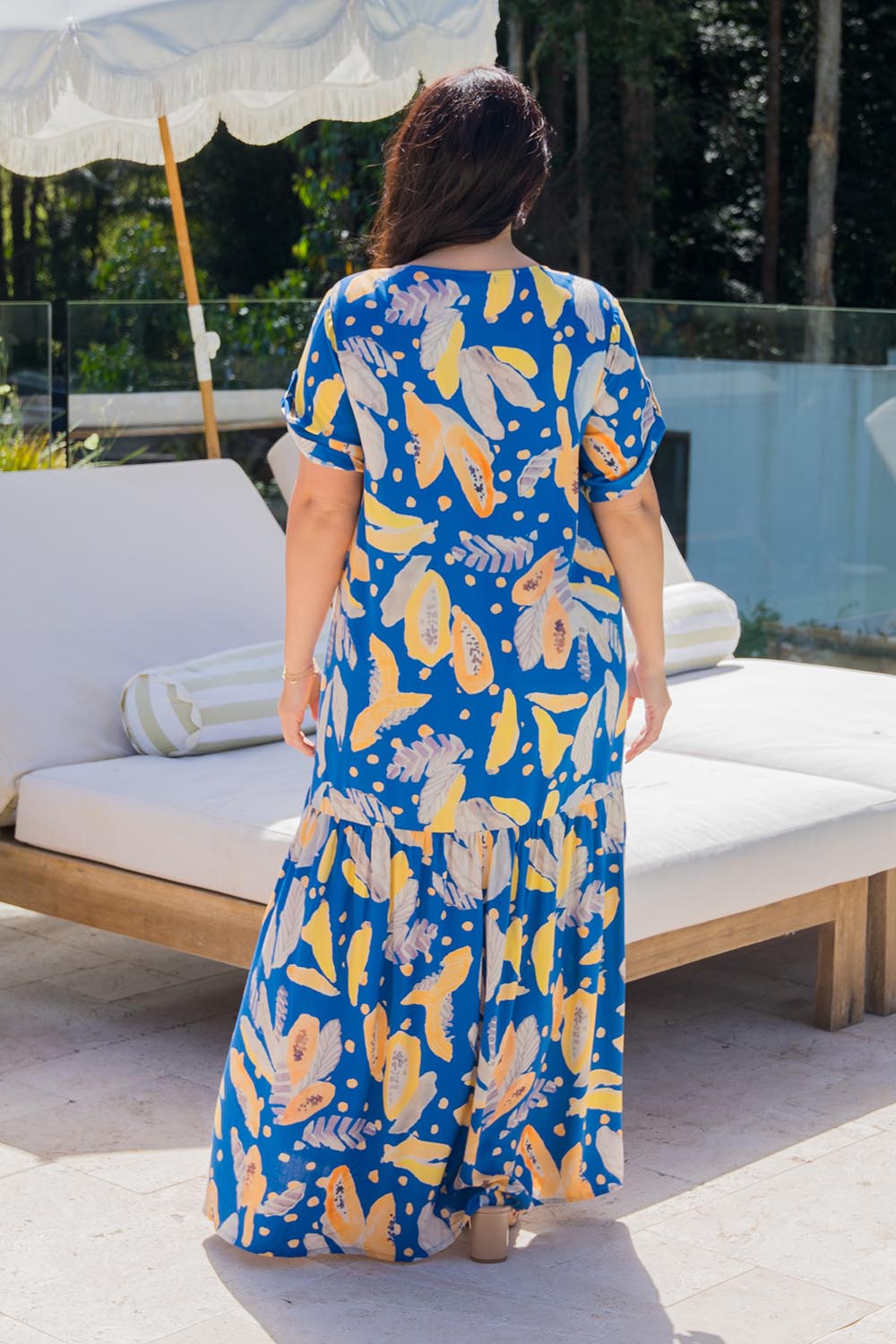 A model wearing the Peak Maxi Dress in colour Fruitpunch (Blue), from the back