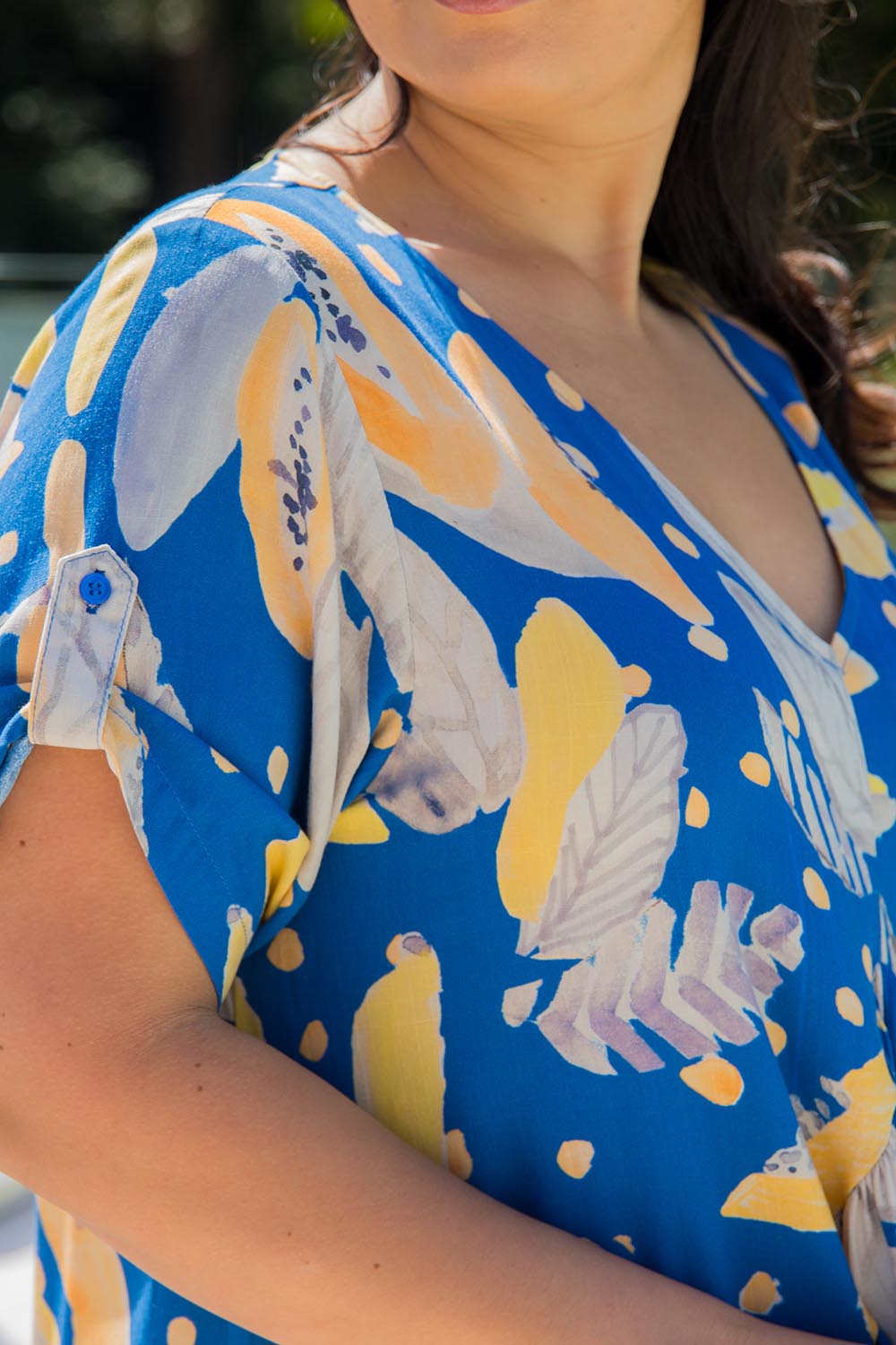 A model wearing the Peak Maxi Dress in colour Fruitpunch (Blue), from the front, cropped image