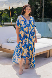 A model wearing the Peak Maxi Dress in colour Fruitpunch (Blue), from the front, showing the whole outfit