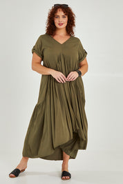Model Maddy wearing the Short Sleeve Peak Maxi Dress in colour Khaki (Green), from the front, showing the whole outfit