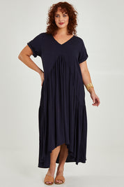 Model Maddy wearing the Short Sleeve Peak Maxi Dress in colour Navy (Blue), from the front, showing the whole outfit