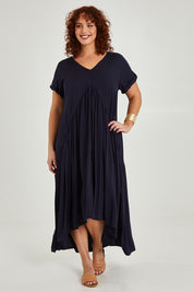 Model Maddy wearing the Short Sleeve Peak Maxi Dress in colour Navy (Blue), from the front, showing the whole outfit