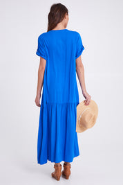 Model Madeline wearing the S/S Peak Maxi Dress in colour Bahama (Blue), from the back