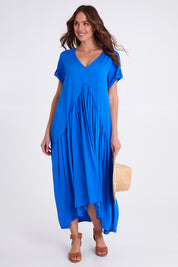 Model Madeline wearing the S/S Peak Maxi Dress in colour Bahama (Blue), from the front, showing the whole outfit