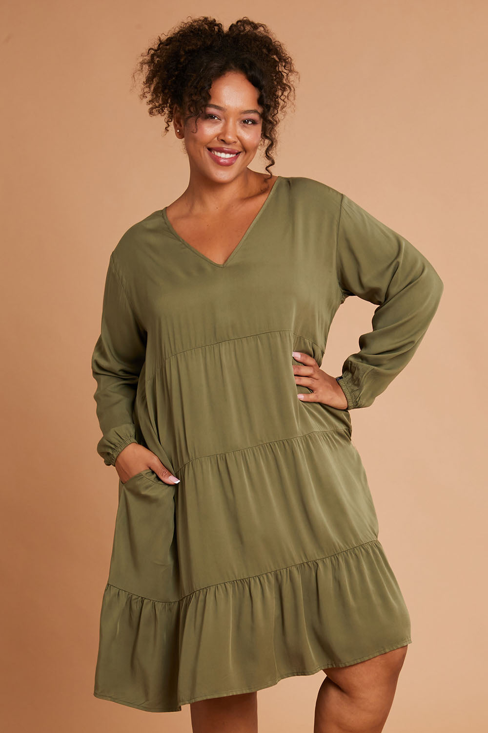 Model Alexis wearing the Long Sleeve Chic Dress in colour Khaki (Green), from the front, cropped image