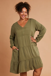 Model Alexis wearing the Long Sleeve Chic Dress in colour Khaki (Green), from the front, cropped image
