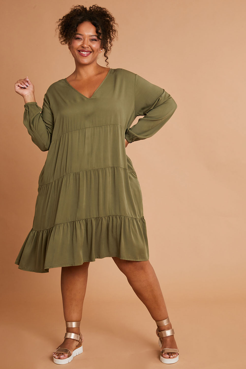 Model Alexis wearing the Long Sleeve Chic Dress in colour Khaki (Green), from the front, showing the whole outfit