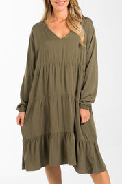 A model wearing the Long Sleeve Chic Dress in colour Khaki (Green), from the front, cropped image