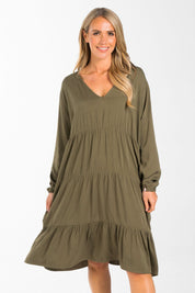 A model wearing the Long Sleeve Chic Dress in colour Khaki (Green), from the front, cropped image