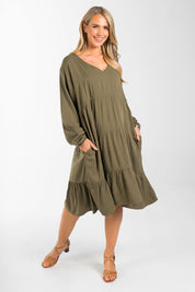 A model wearing the Long Sleeve Chic Dress in colour Khaki (Green), from the front, showing the whole outfit