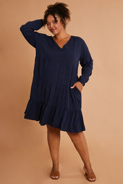 Model Alexis wearing the Long Sleeve Chic Dress in colour Navy (Blue), from the front, showing the whole outfit