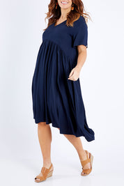 Model Laura wearing size M of the Wander Dress in colour Navy (Blue), from the front, cropped image