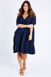 Model Laura wearing the Chic Dress in colour Navy (Blue), from the front, showing the whole outfit