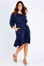 Model Laura wearing the Flare Dress in colour Navy (Blue), from the front, showing the whole outfit