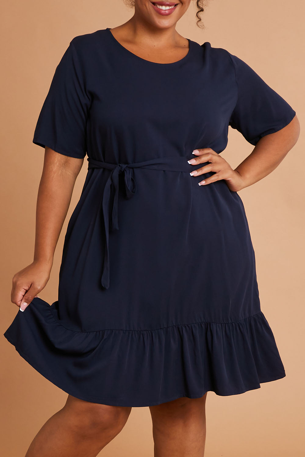 Model Alexis wearing the Short Sleeve Flare Dress in colour Navy (Blue), from the front, cropped image