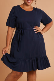 Model Alexis wearing the Short Sleeve Flare Dress in colour Navy (Blue), from the front, cropped image