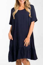 A model wearing the Short Sleeve Flare Dress in colour Navy (Blue), from the front, cropped image