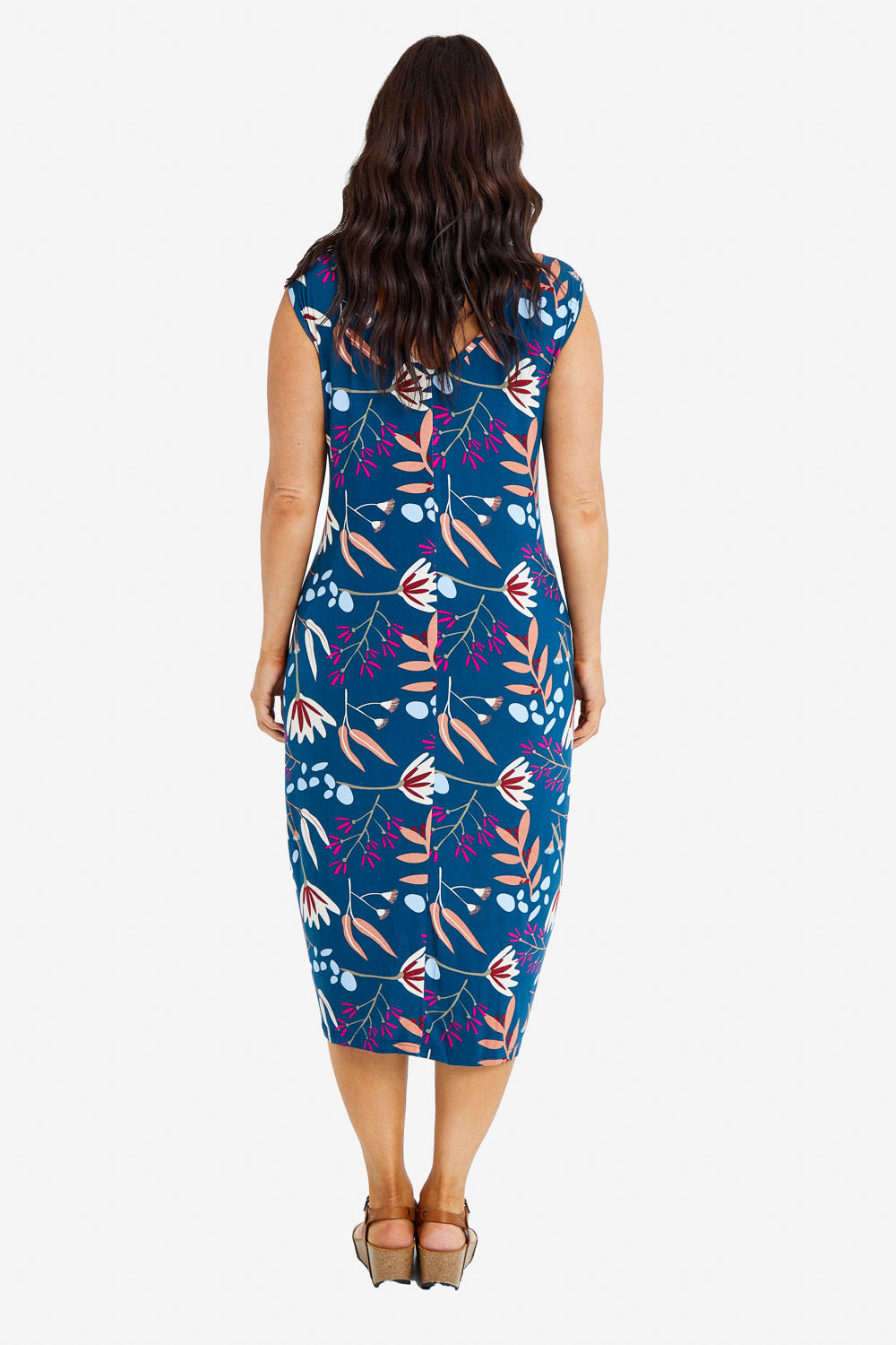 Model Laura wearing the Sleeveless Tidal Multi Wear Dress in colour Nightbloom (Blue), from the back