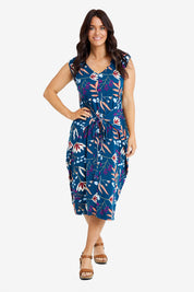 Model Laura wearing the Sleeveless Tidal Multi Wear Dress in colour Nightbloom (Blue), from the front, showing the whole outfit