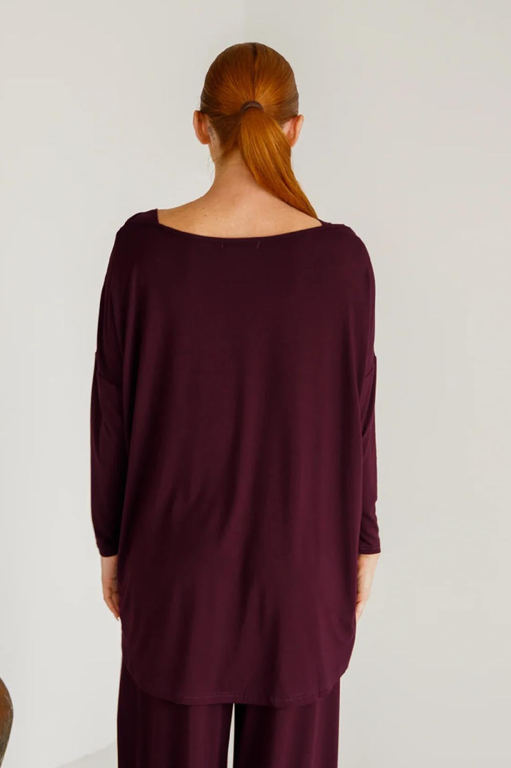 A model wearing the Pippa Bamboo Top in colour Shiraz (Purple), from the back