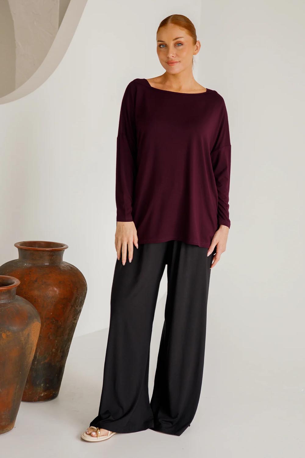 A model wearing the Pippa Bamboo Top in colour Shiraz (Purple), from the front, showing the whole outfit