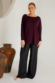A model wearing the Pippa Bamboo Top in colour Shiraz (Purple), from the front, showing the whole outfit