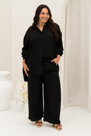 A model wearing the Amore Tencel Shirt in colour Black (Black), from the front, showing the whole outfit
