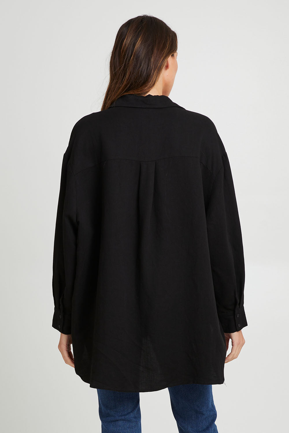 Model Madeline wearing the Amore Tencel Shirt in colour Black (Black), from the back