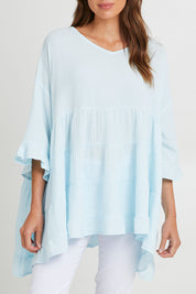 Model Madeline wearing the Sofia Top in colour Blue (Blue), from the front, cropped image