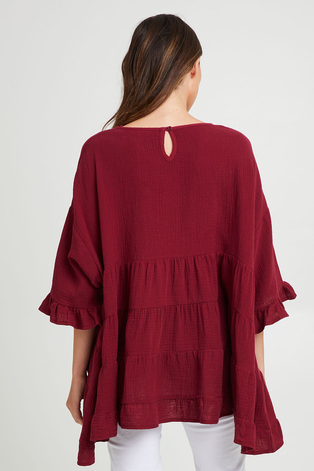 Model Madeline wearing the Sofia Top in colour Mahogany (Pink), from the back
