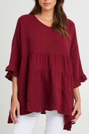 Model Madeline wearing the Sofia Top in colour Mahogany (Pink), from the front, cropped image
