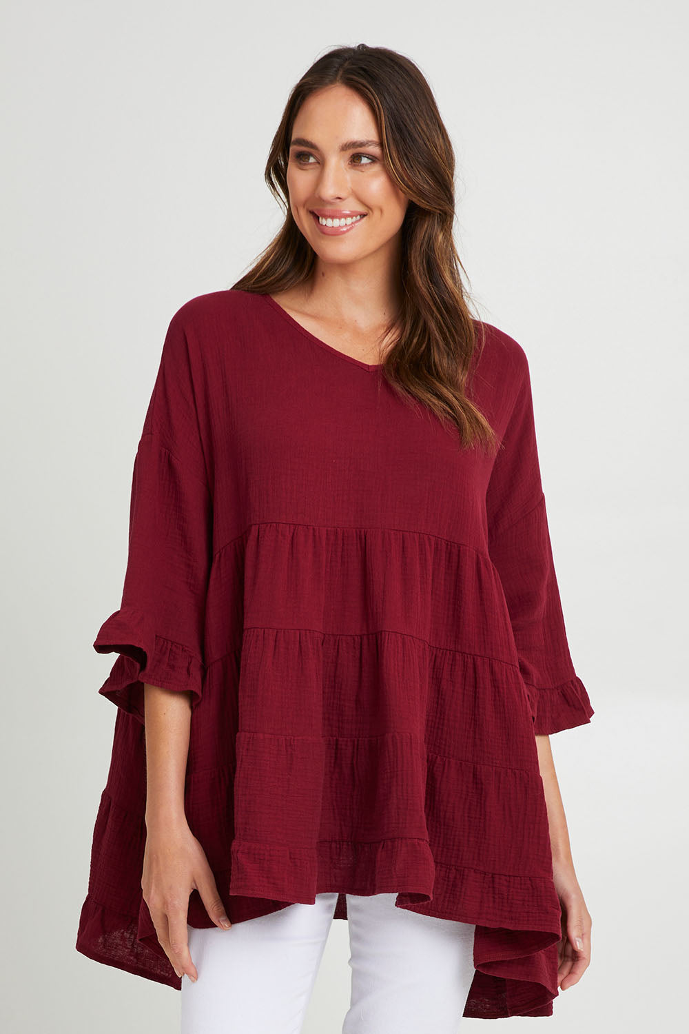 Model Madeline wearing the Sofia Top in colour Mahogany (Pink), from the front, cropped image