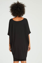 Model Olivia wearing size OneSize of the Hi Low Top in colour Black (Black), from the back