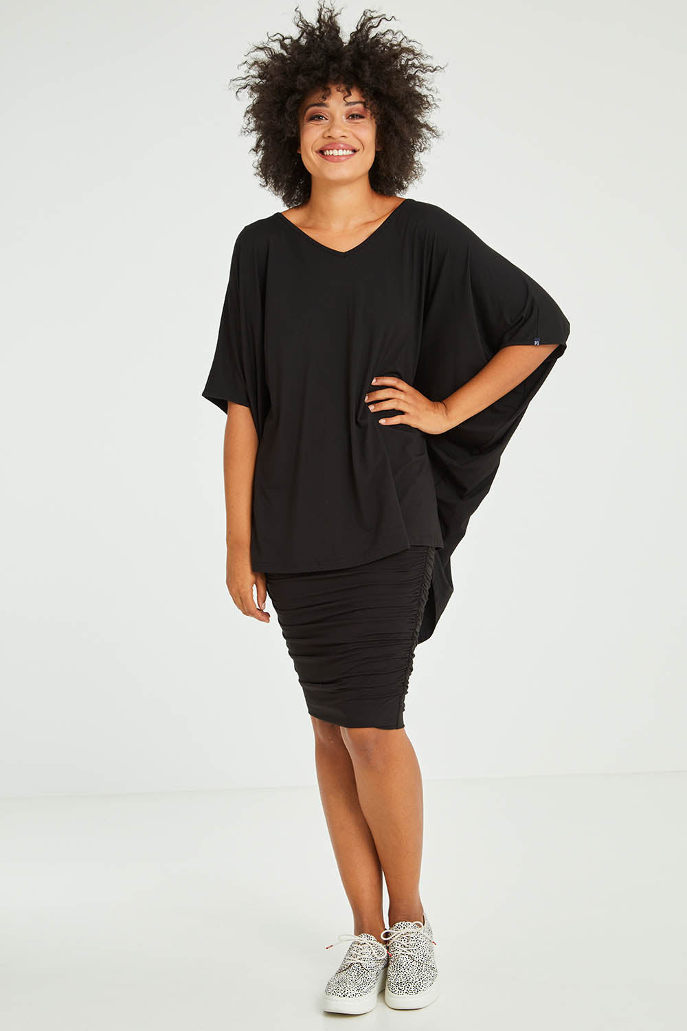 Model Olivia wearing size OneSize of the Hi Low Top in colour Black (Black), from the front, showing the whole outfit