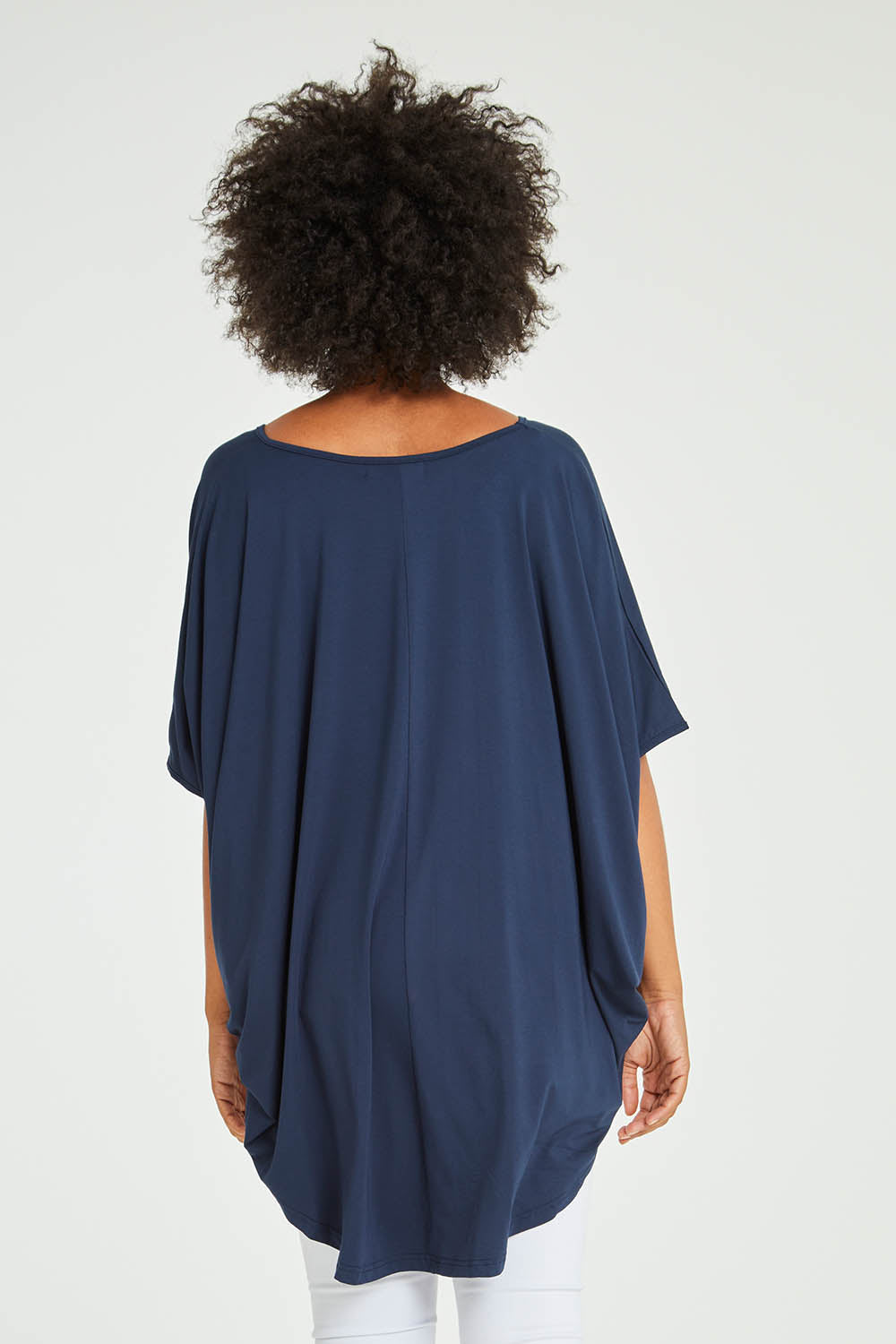 Model Olivia wearing size OneSize of the Hi Low Top in colour Navy (Blue), from the back