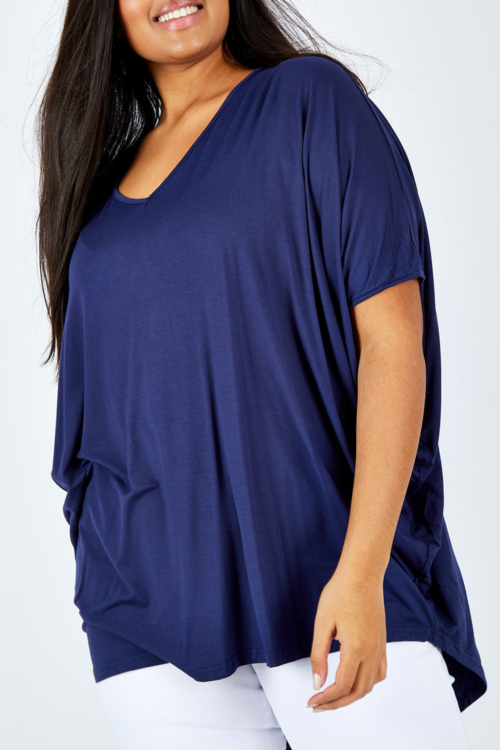 Model Shanaya wearing size OneSize of the Hi Low Top in colour Navy (Blue), from the front, cropped image