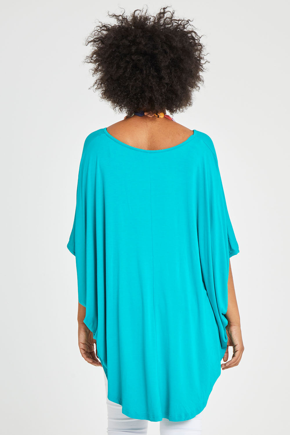 Model Olivia wearing size OneSize of the Hi Low Miracle Bamboo Top in colour Jade (Green), from the back