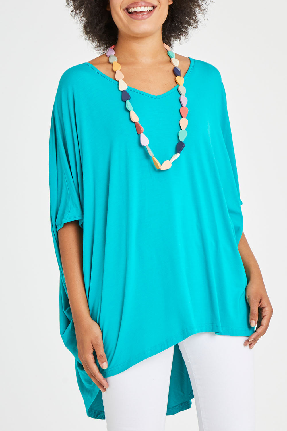 Model Olivia wearing size OneSize of the Hi Low Miracle Bamboo Top in colour Jade (Green), from the front, cropped image