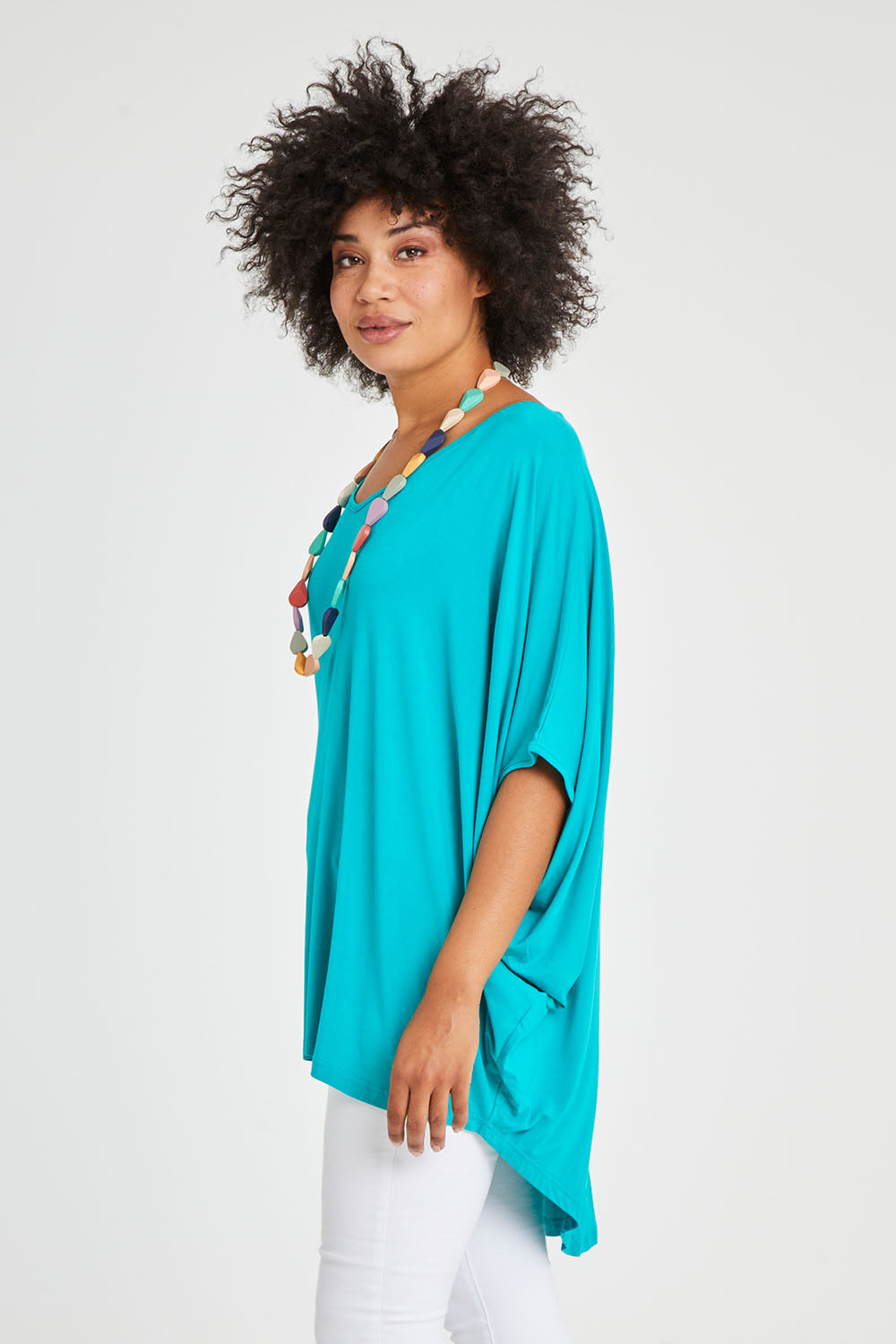 Model Olivia wearing size OneSize of the Hi Low Miracle Bamboo Top in colour Jade (Green), from the front, cropped image