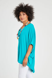 Model Olivia wearing size OneSize of the Hi Low Miracle Bamboo Top in colour Jade (Green), from the front, cropped image